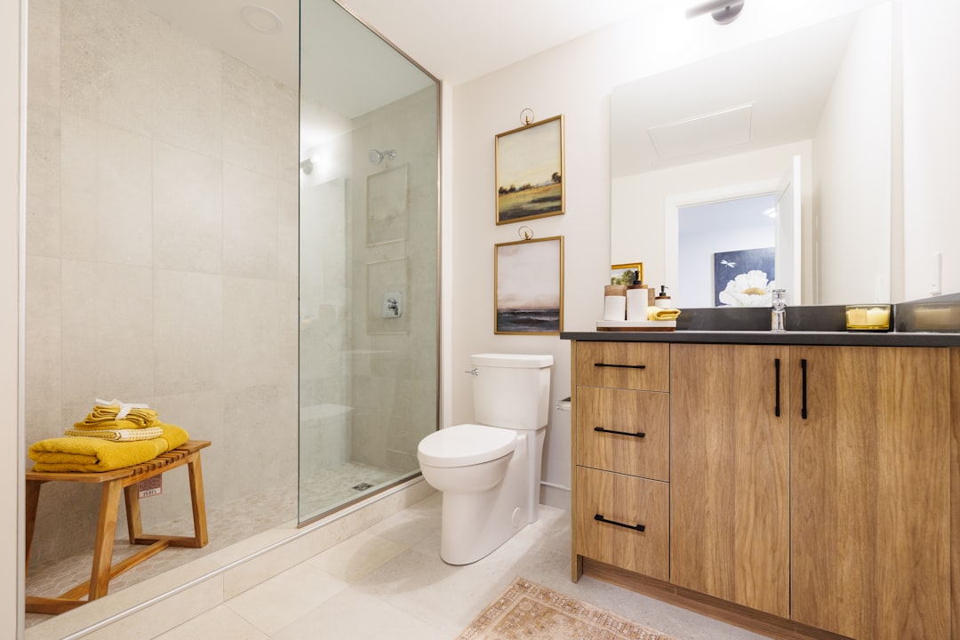 modern-bathroom-with-wooden-vanity-and-glass-shower-t-v8vqndlv4